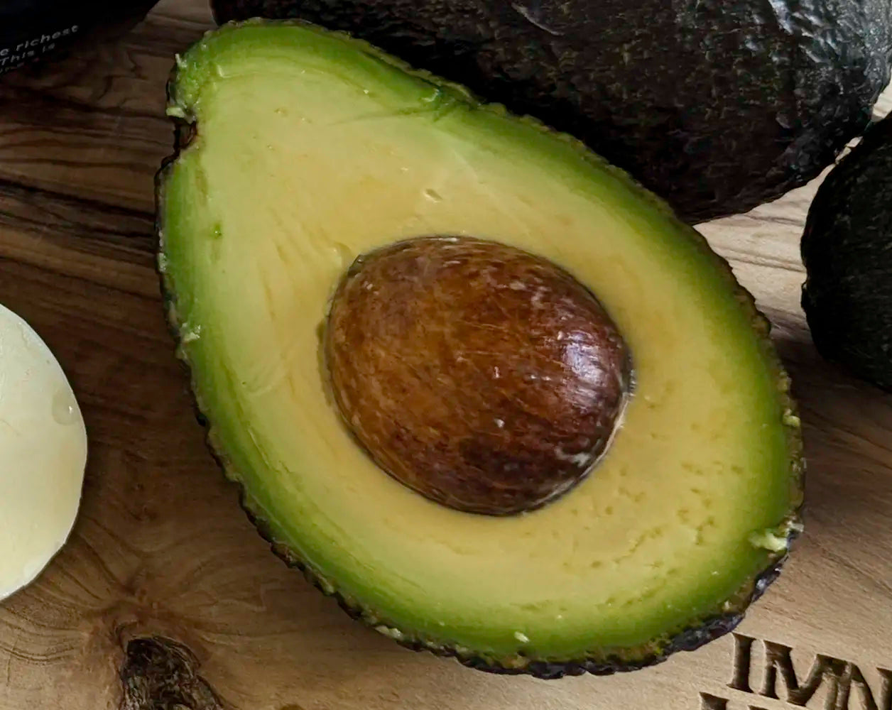 Close-up of an avocado cut in half on a wooden surface