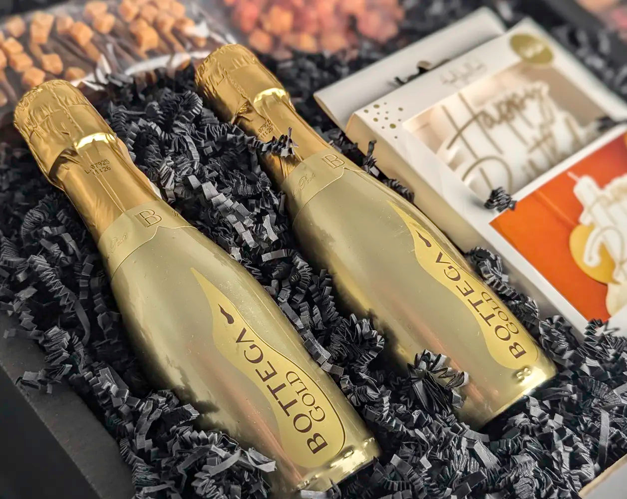 Two gold bottles with 'Bottega Gold' branding in a decorative box.