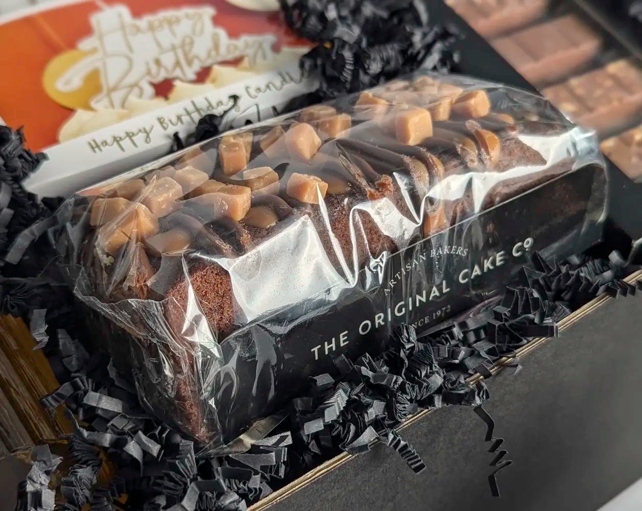 Packaged cake with 'The Original Cake Co' label on a dark background