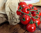 Cherry vine tomatoes on wooden background