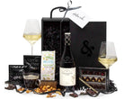 Gourmet gift set with wine, snacks, and coffee on a white background