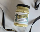 Jar of Tracklements strong horseradish cream on a marble surface